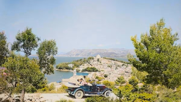 Historic view of Cavtat in the 1920s with vintage car driving along the coastline