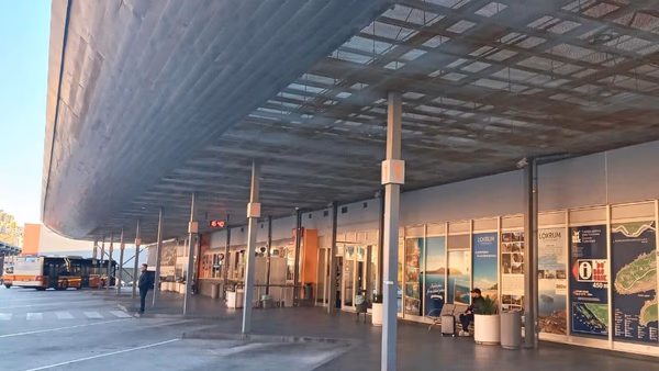 Exterior view of Dubrovnik Main Bus Station at Gruž harbour, with departure shelters and buses
