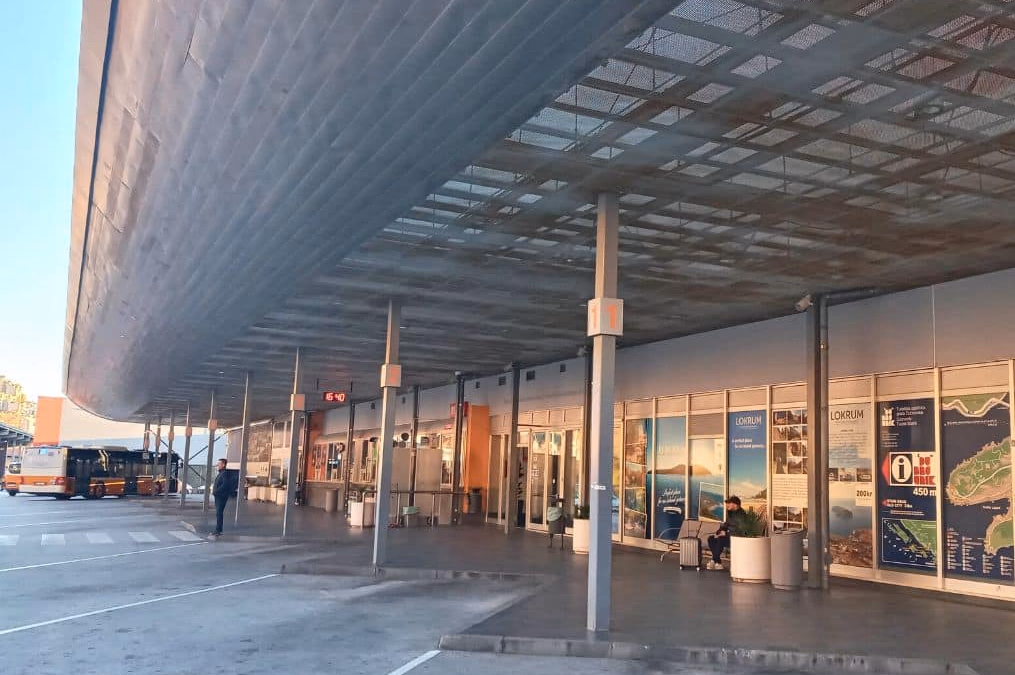 Exterior view of Dubrovnik Main Bus Station at Gruž harbour, with departure shelters and buses