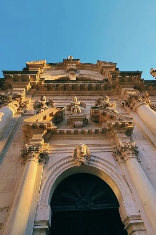 Corinthian columns and sculpted angels on the church façade.