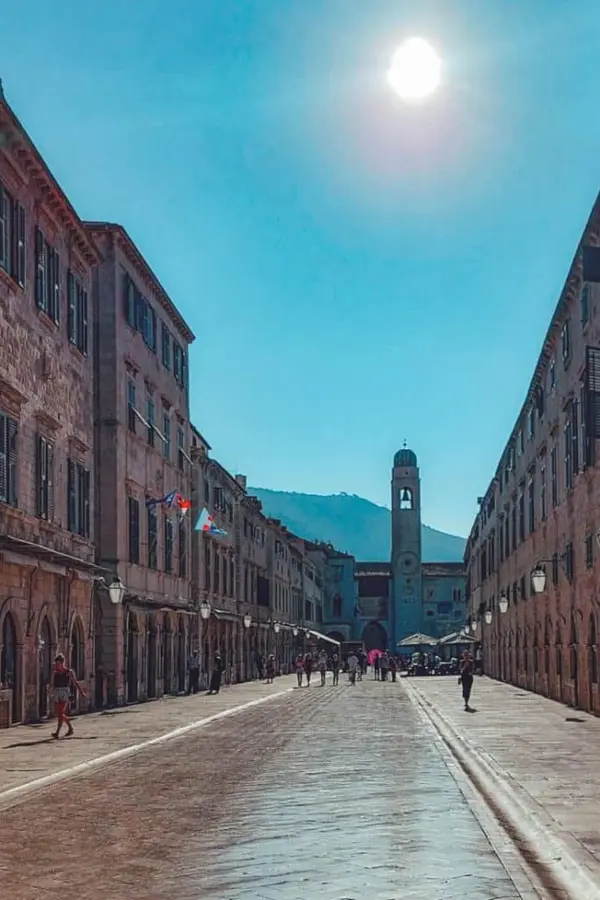 Stradun in mid-afternoon under bright sunlight.