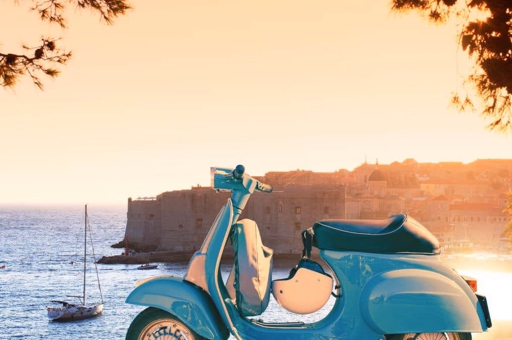 Scooter parked at a Dubrovnik viewpoint above Old Town and the sea.