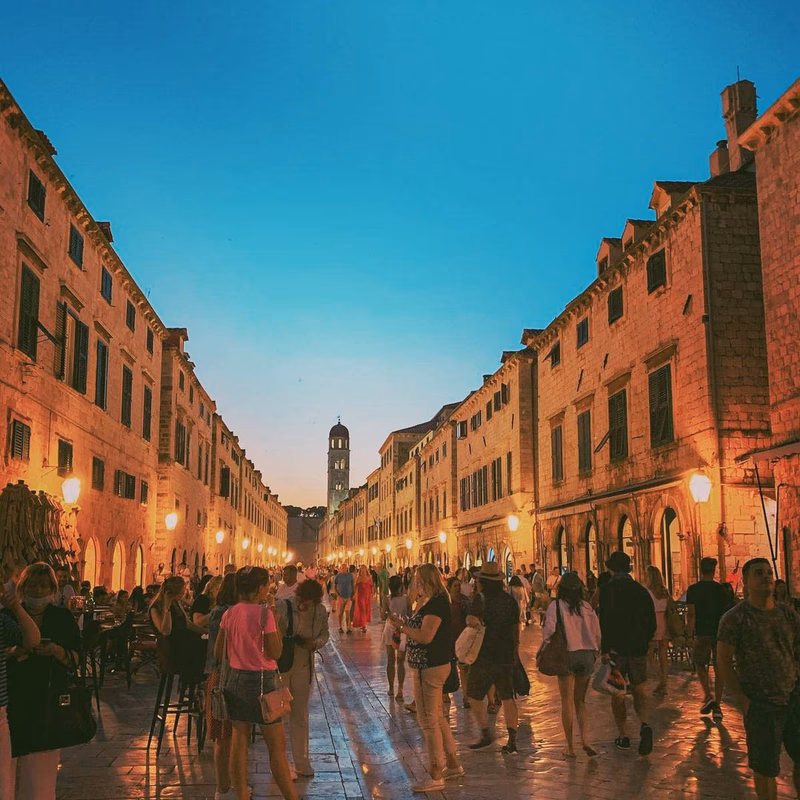 People walking along Stradun in Dubrovnik Old Town.