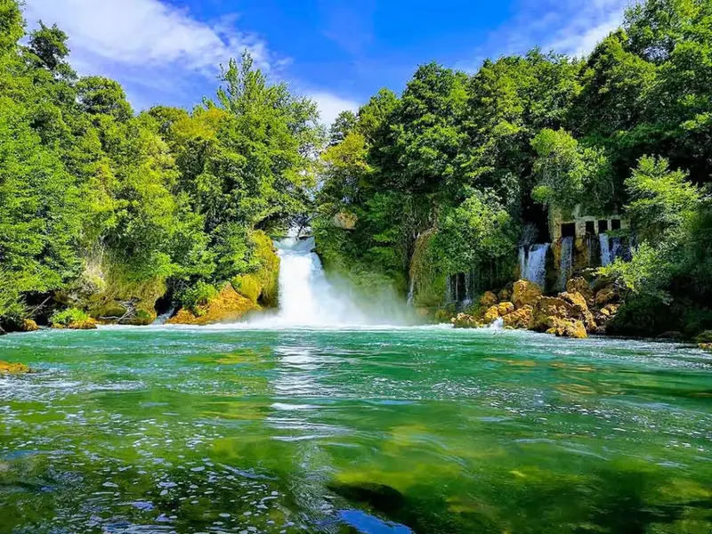 Bilušića Buk waterfall on the upper Krka River with terraced tufa steps.