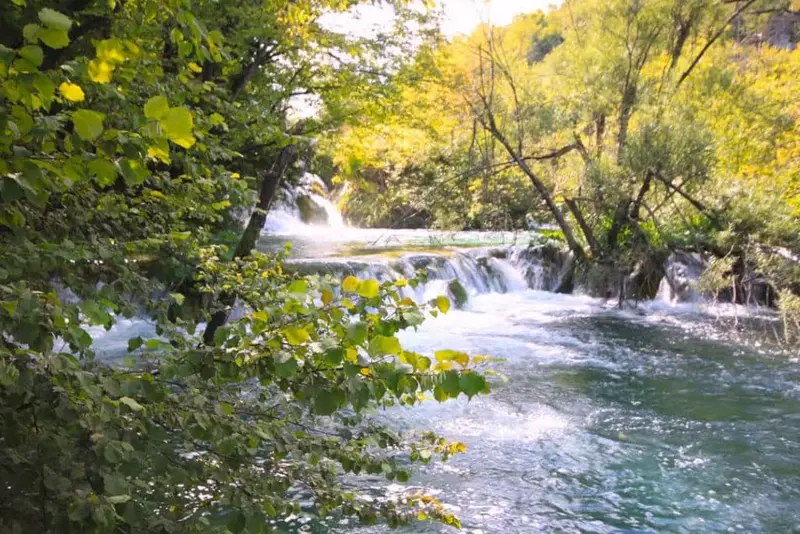 Milke Trnine waterfall flowing into turquoise pools at Plitvice Lakes.