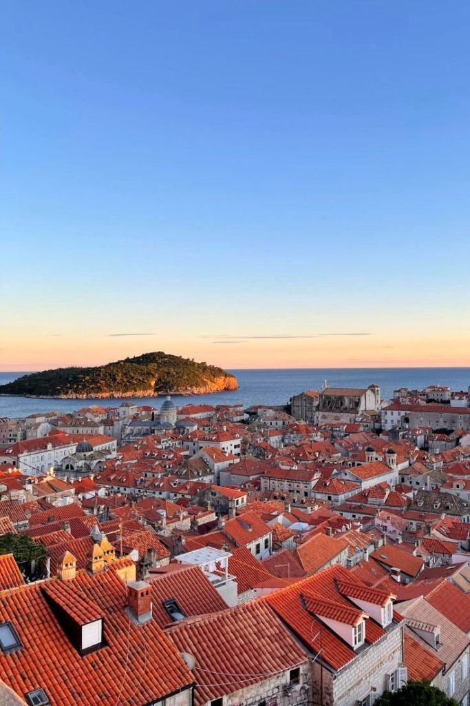 View from Dubrovnik City Walls over Old Town's red rooftops and major landmarks.